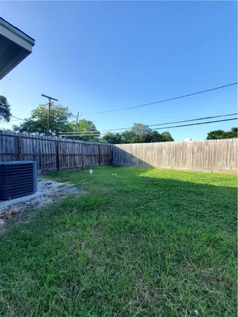 a view of a backyard with wooden fence