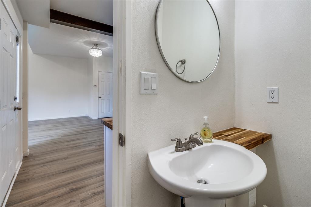8404 Forest Lane, Unit 702 Dallas, TX 75243 - Photo 8 of 12 a bathroom with a sink and a mirror