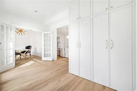 a dining room with furniture and a painting on the wall