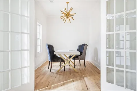 a view of a dining room with furniture and wooden floor