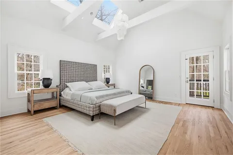 a spacious bedroom with a bed and a large window