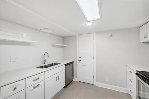 a view of an empty room with a fireplace and a window