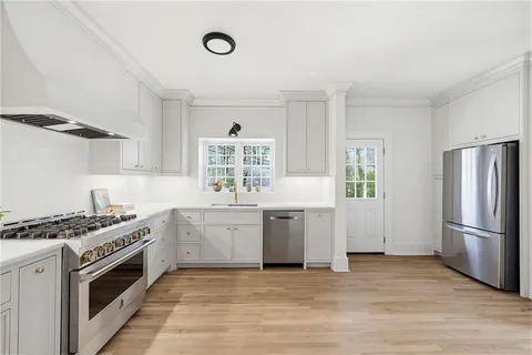 a kitchen with a stove a sink and a refrigerator