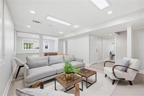 a kitchen with stainless steel appliances a refrigerator sink and white cabinets