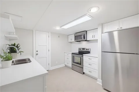 a large bedroom with a bed and a dresser