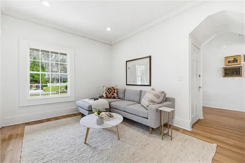 a living room with furniture and a refrigerator