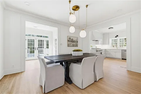 a view of a living room and kitchen with wooden floor