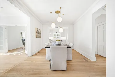 a view of a livingroom with wooden floor and a ceiling fan