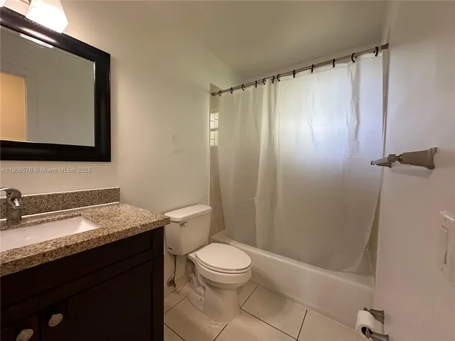 an outdoor sitting area with furniture and wooden floor
