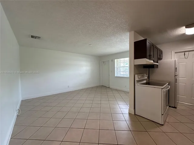 a kitchen with a sink a stove and cabinets