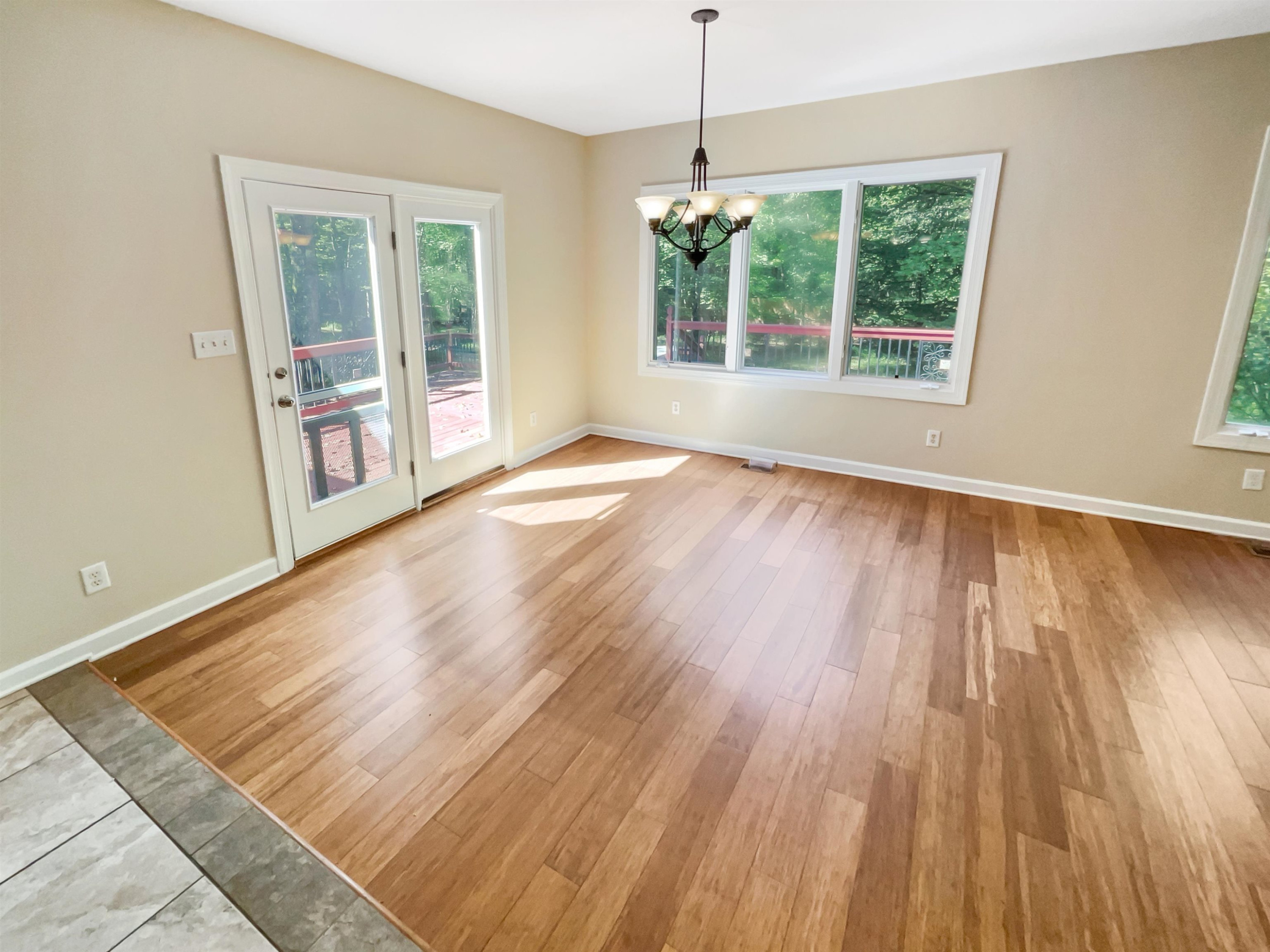 8401 Wolverton Fields Drive Wake Forest, NC 27587 - Photo 4 of 19 a view of an empty room with wooden floor and a window