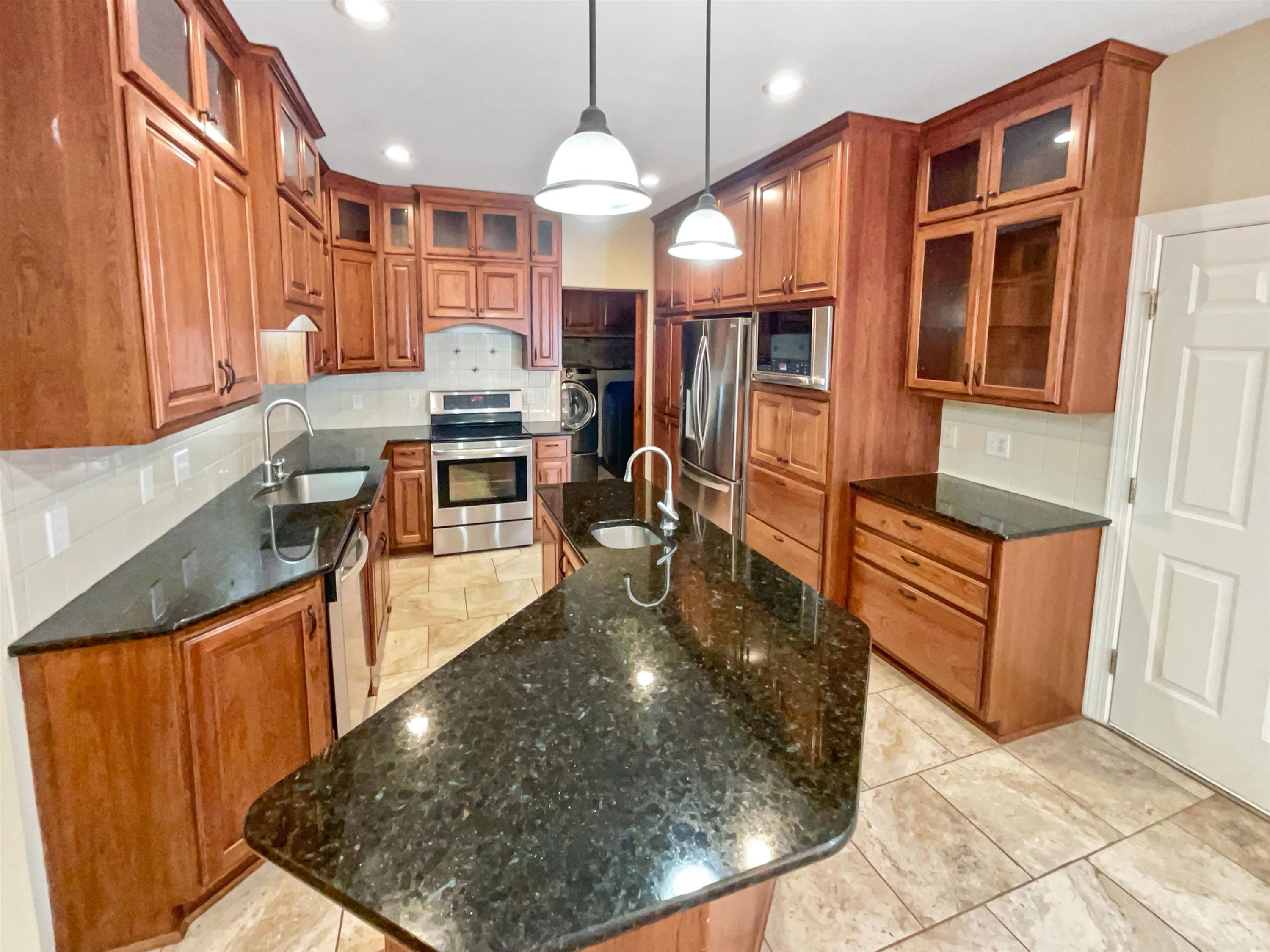 8401 Wolverton Fields Drive Wake Forest, NC 27587 - Photo 6 of 19 a kitchen with stainless steel appliances granite countertop a stove refrigerator and a microwave oven