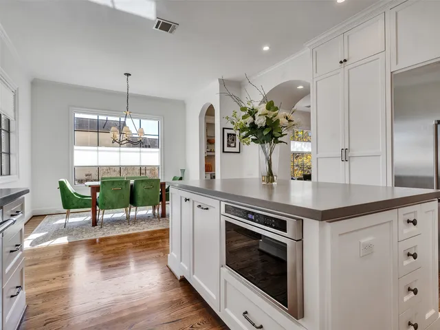 a view of a living room and kitchen with wooden floor