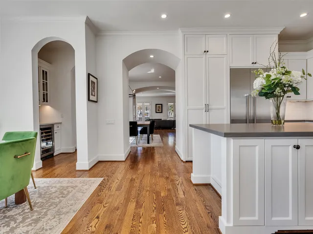 a view of a dining room with furniture a chandelier and wooden floor