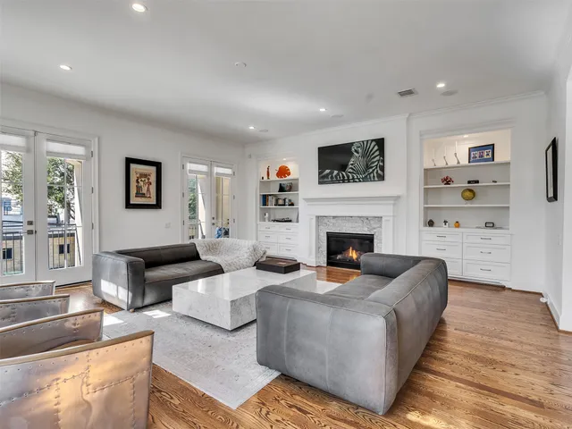 a living room with fireplace furniture and a wooden floor