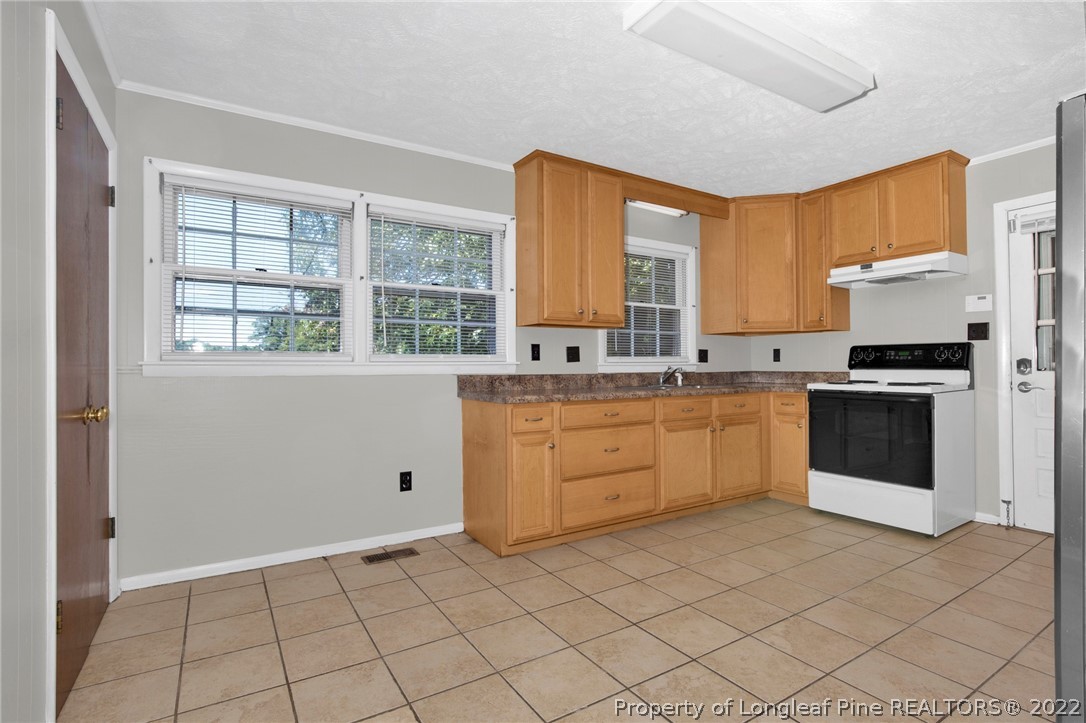 691 Wade-Stedman Road Stedman, NC 28391 - Photo 6 of 19 a kitchen with white cabinets and white appliances