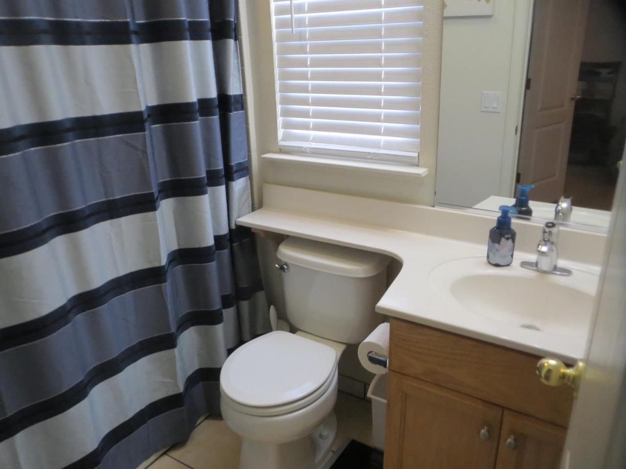 4125 Pathway Lane Turlock, CA 95382 - Photo 12 of 15 a bathroom with a sink and a toilet