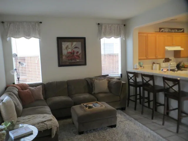 a living room with furniture and a large window