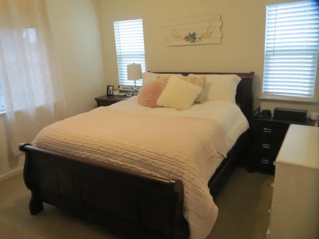 a bedroom with a bed and window