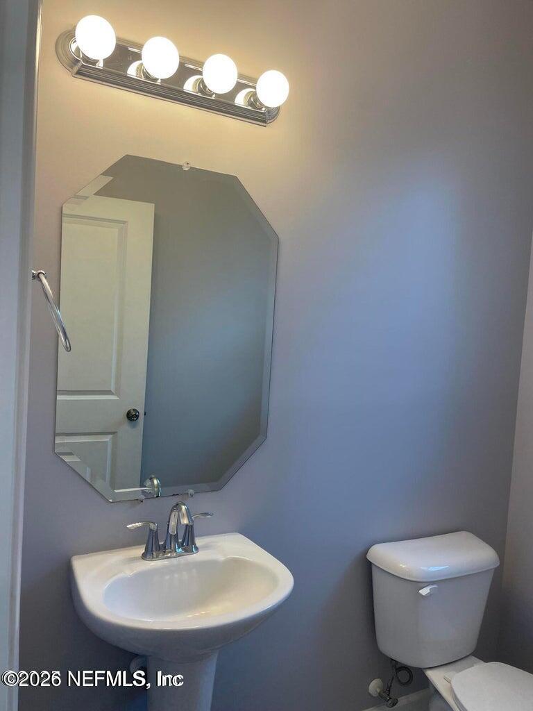 142 Jackrabbit Trail Ponte Vedra, FL 32081 - Photo 14 of 77 a bathroom with a toilet sink and mirror