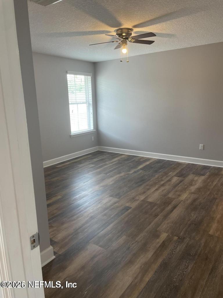 142 Jackrabbit Trail Ponte Vedra, FL 32081 - Photo 20 of 77 an empty room with wooden floor fan and windows