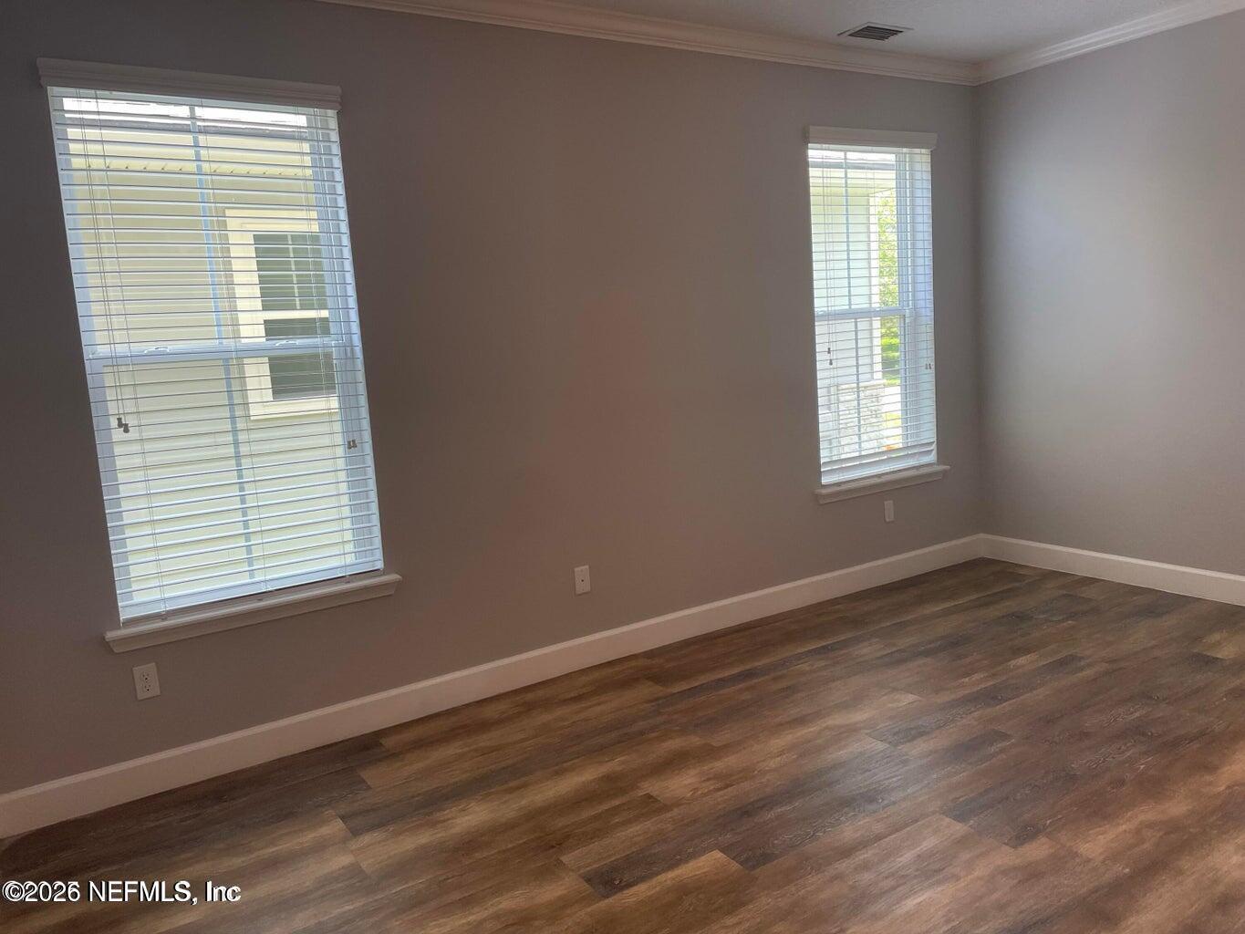 142 Jackrabbit Trail Ponte Vedra, FL 32081 - Photo 21 of 77 a view of an empty room with wooden floor and a window