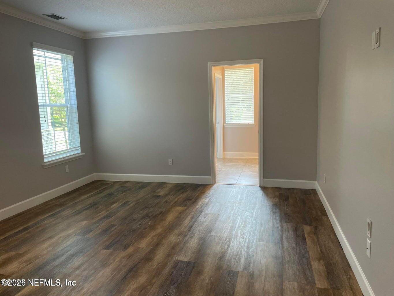 142 Jackrabbit Trail Ponte Vedra, FL 32081 - Photo 22 of 77 an empty room with wooden floor and windows