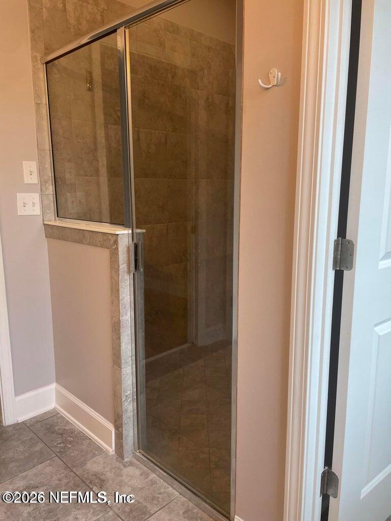 142 Jackrabbit Trail Ponte Vedra, FL 32081 - Photo 25 of 77 a bathroom with a glass shower door