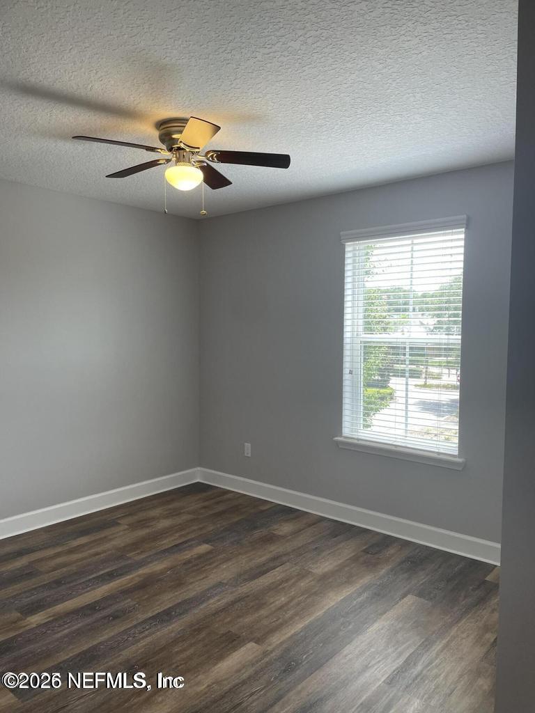 142 Jackrabbit Trail Ponte Vedra, FL 32081 - Photo 38 of 77 an empty room with wooden floor fan and windows