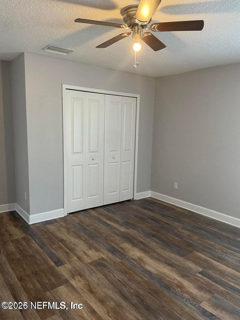 142 Jackrabbit Trail Ponte Vedra, FL 32081 - Photo 47 of 77 an empty room with wooden floor closet fan and windows