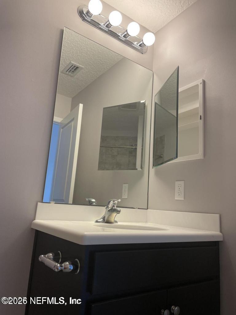 142 Jackrabbit Trail Ponte Vedra, FL 32081 - Photo 48 of 77 a bathroom with a sink and a mirror