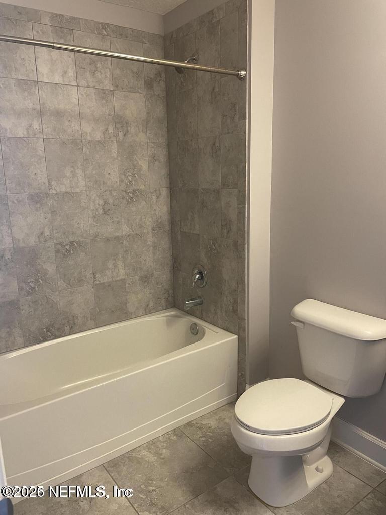 142 Jackrabbit Trail Ponte Vedra, FL 32081 - Photo 49 of 77 a white toilet sitting next to a bath tub and a shower