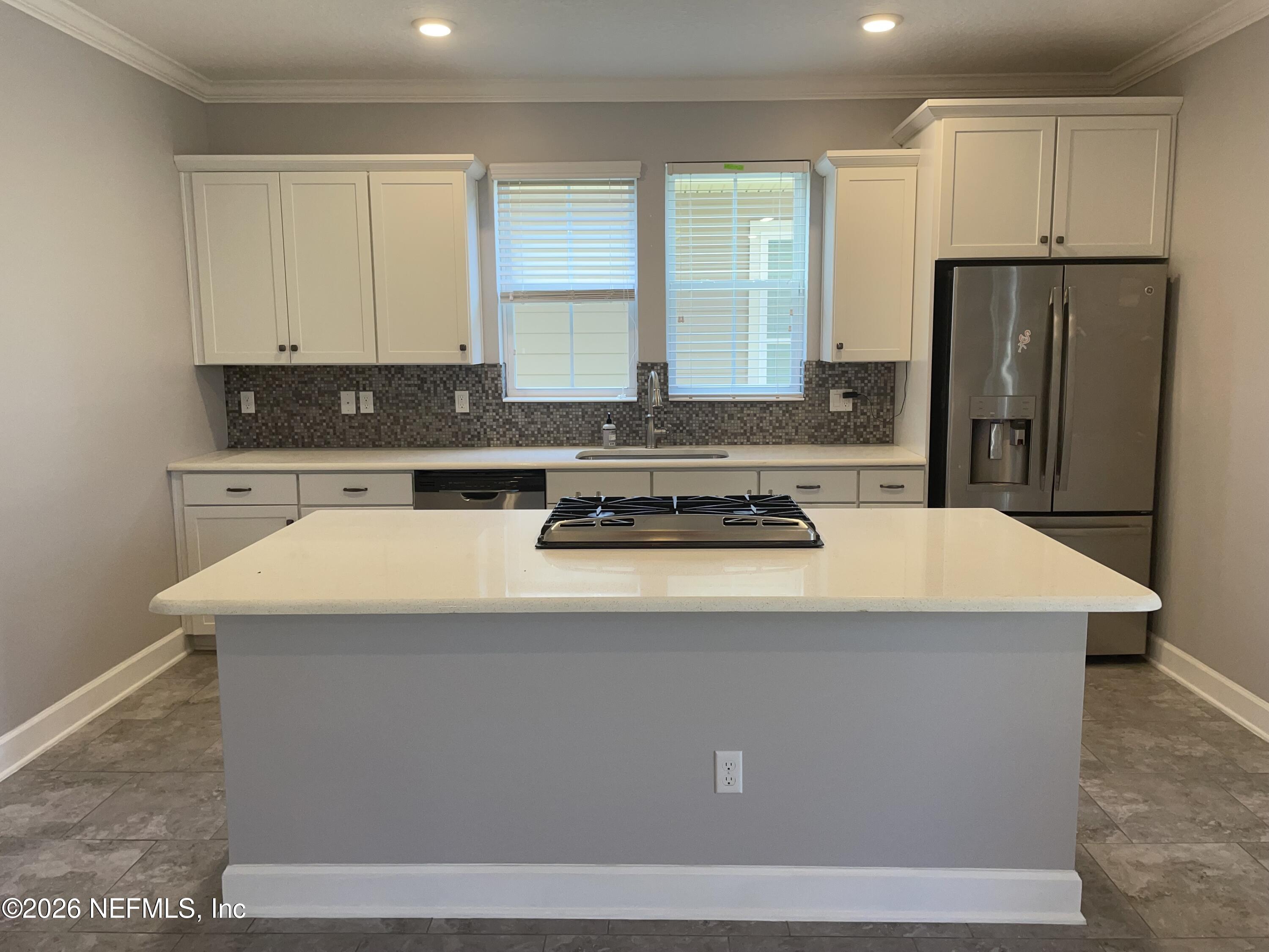 142 Jackrabbit Trail Ponte Vedra, FL 32081 - Photo 6 of 77 a kitchen with kitchen island a sink a stove a refrigerator and white cabinets