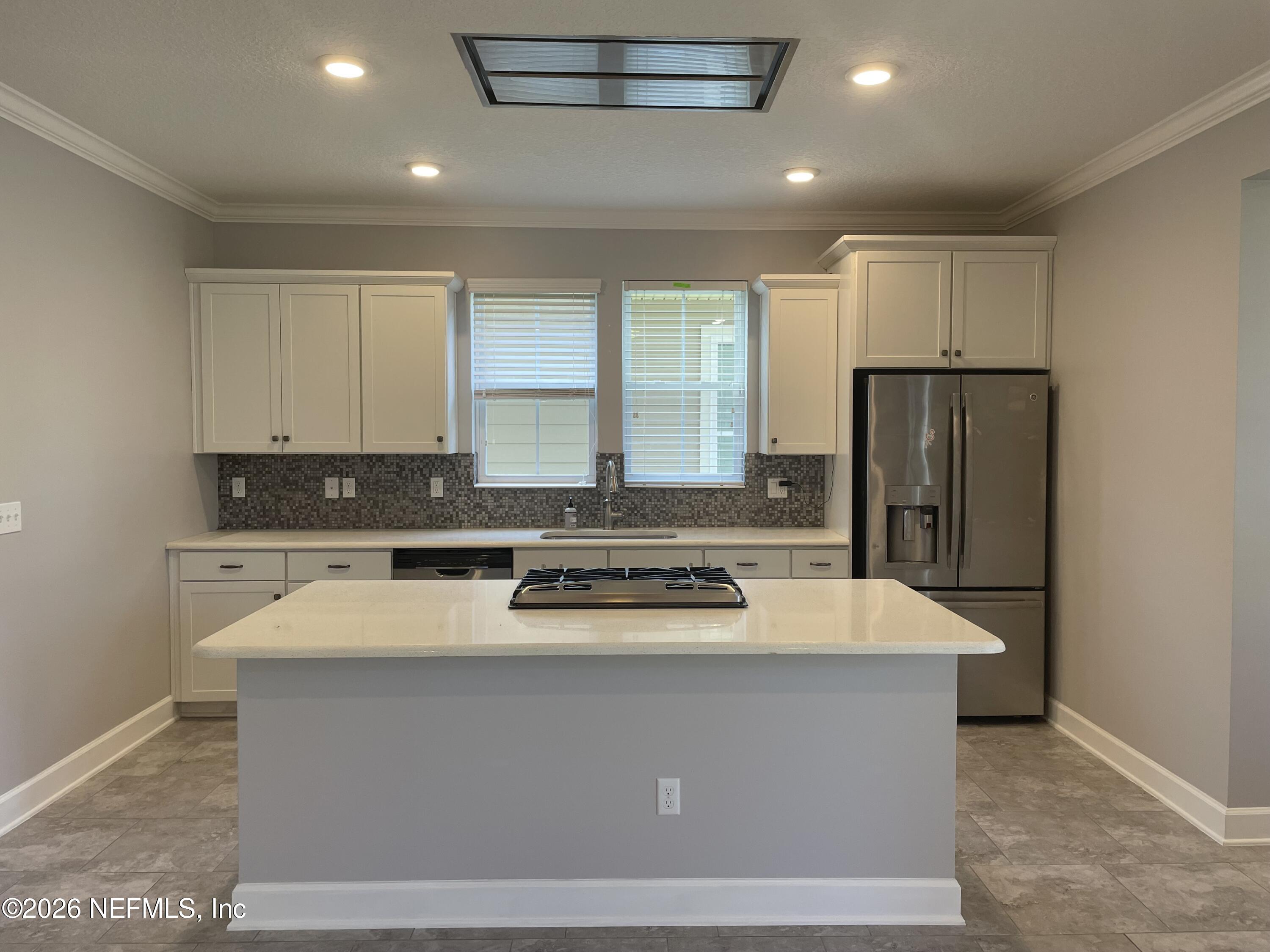 142 Jackrabbit Trail Ponte Vedra, FL 32081 - Photo 7 of 77 a kitchen with kitchen island granite countertop cabinets and refrigerator