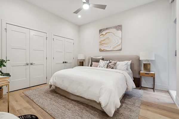 a bedroom with a bed and a chandelier