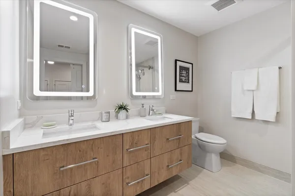 a bathroom with a toilet sink and mirror