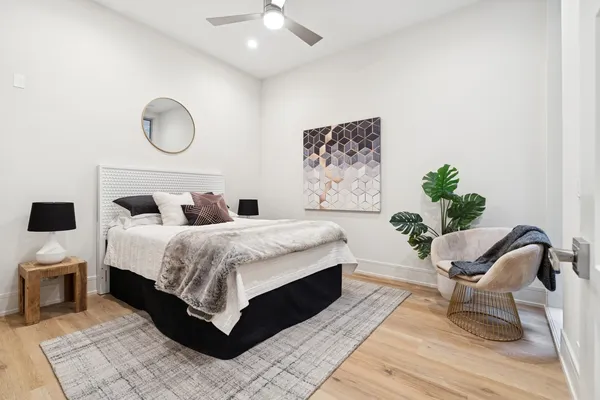 a bedroom with a bed and a chandelier