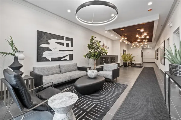 a living room with furniture and a chandelier