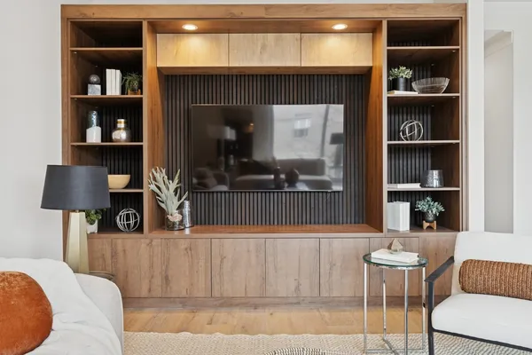 a living room with furniture and a lamp