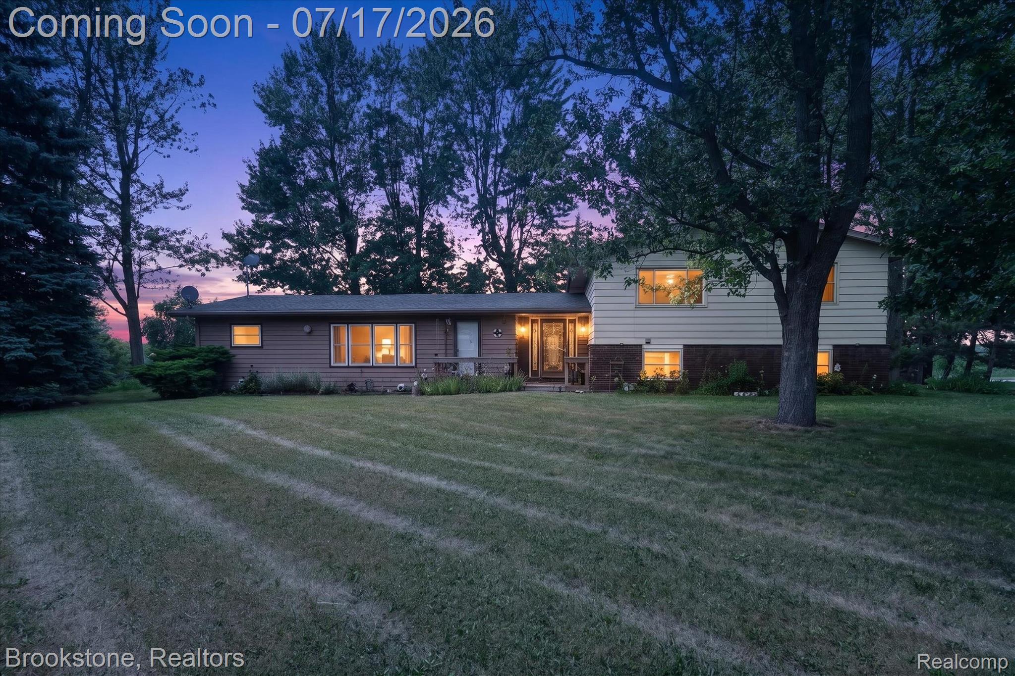 22025 Lakefield Road Merrill, MI 48637 - Photo 1 of 47 Exterior residence featuring two distinct siding materials, multiple windows, and a prominent front entrance