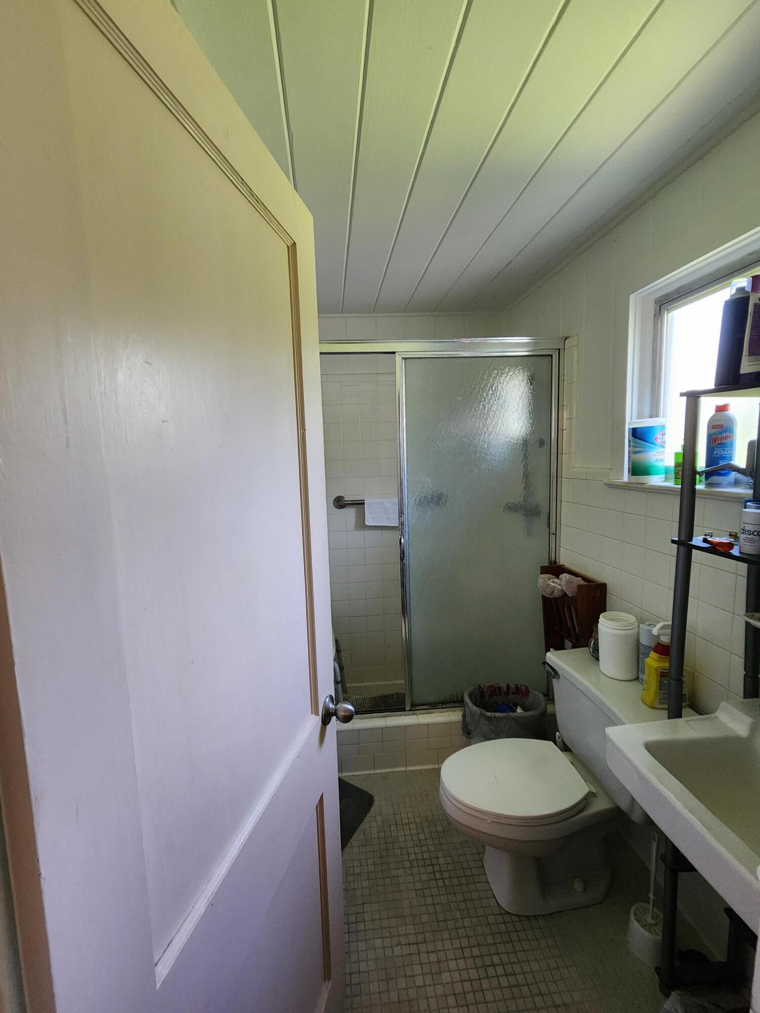 2727 Bacom Point Road Pahokee, FL 33476 - Photo 14 of 34 a bathroom with a sink a toilet and shower