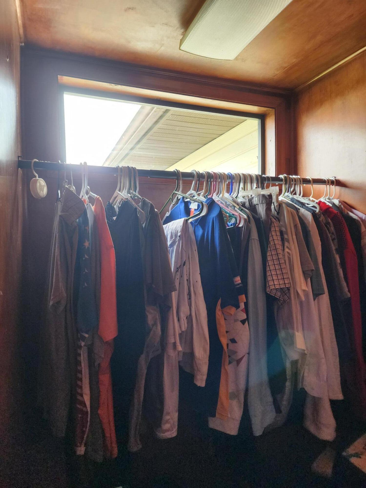 2727 Bacom Point Road Pahokee, FL 33476 - Photo 19 of 34 a view of walk in closet with clothes and shoes