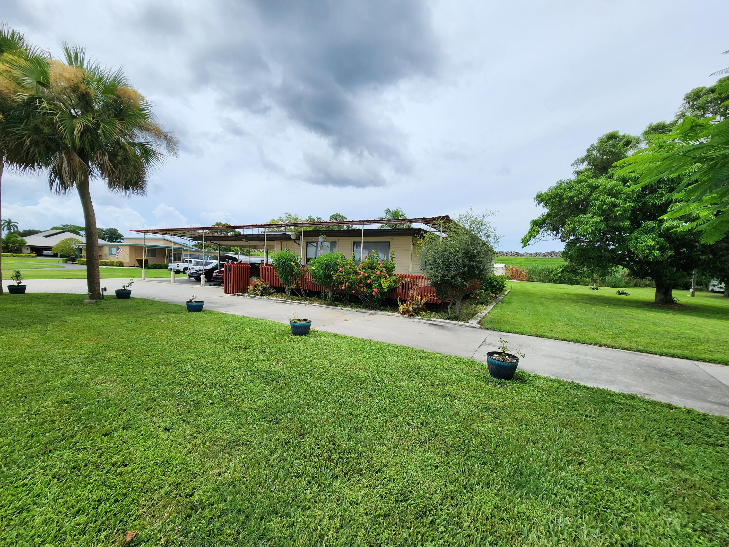 2727 Bacom Point Road Pahokee, FL 33476 - Photo 2 of 34 a view of a garden with lots of swings and slides