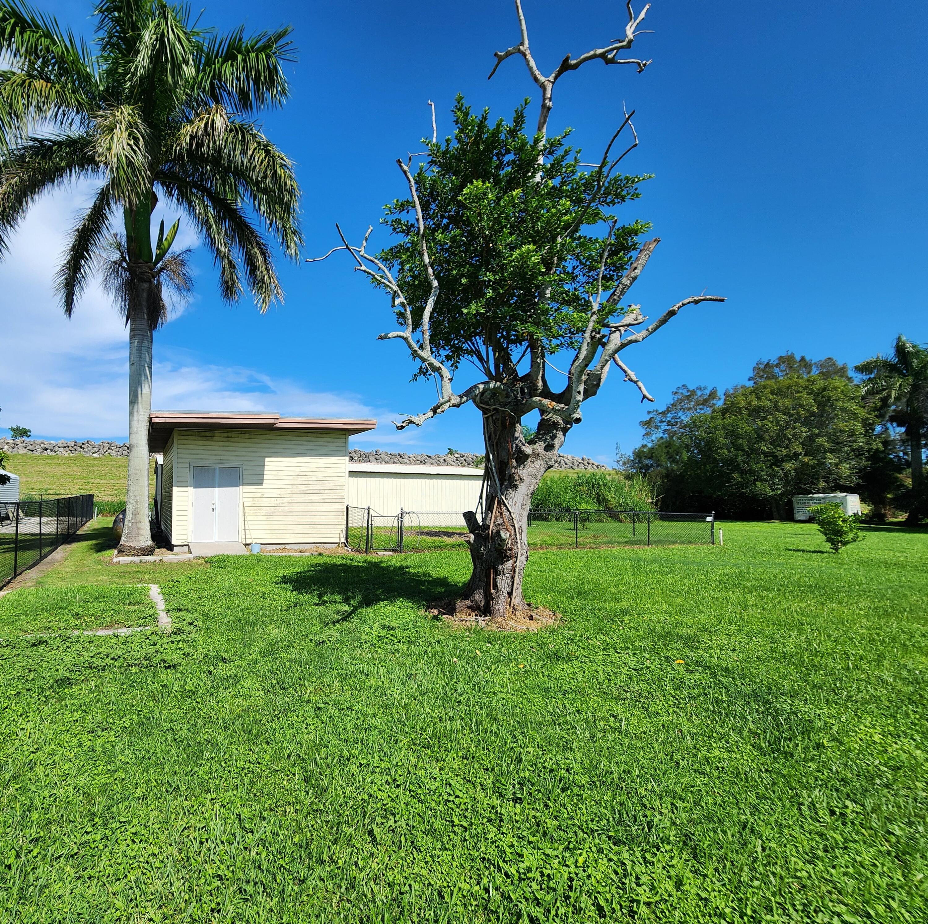 2727 Bacom Point Road Pahokee, FL 33476 - Photo 23 of 34 a view of a house with a yard