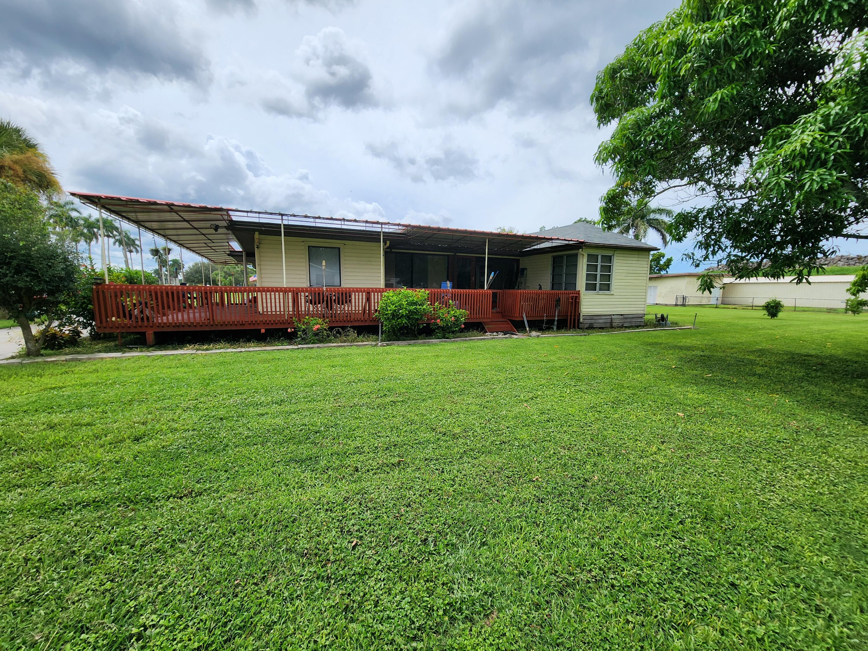 2727 Bacom Point Road Pahokee, FL 33476 - Photo 5 of 34 a view of a yard in front of a house