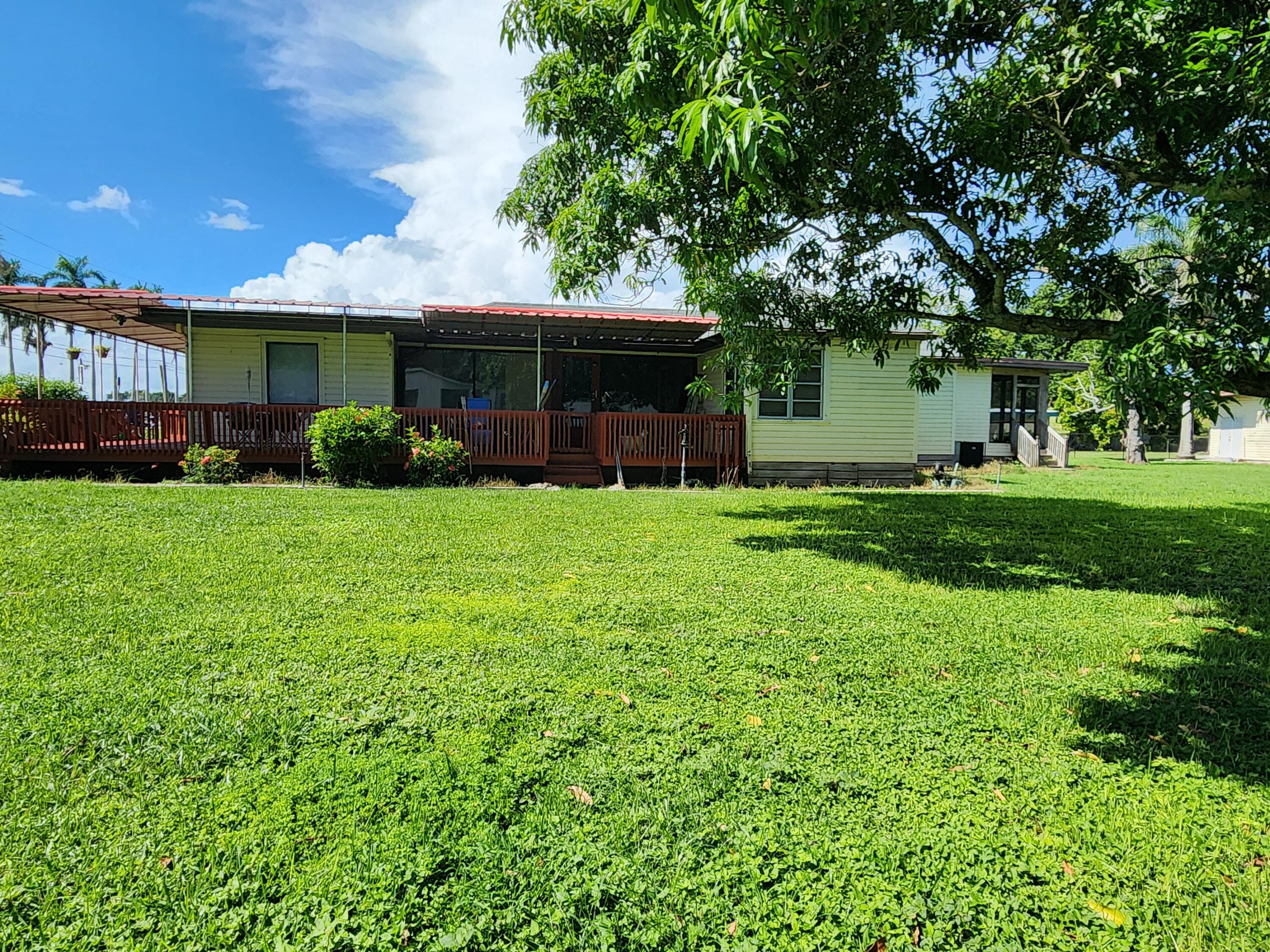 2727 Bacom Point Road Pahokee, FL 33476 - Photo 6 of 34 a view of a house with a yard