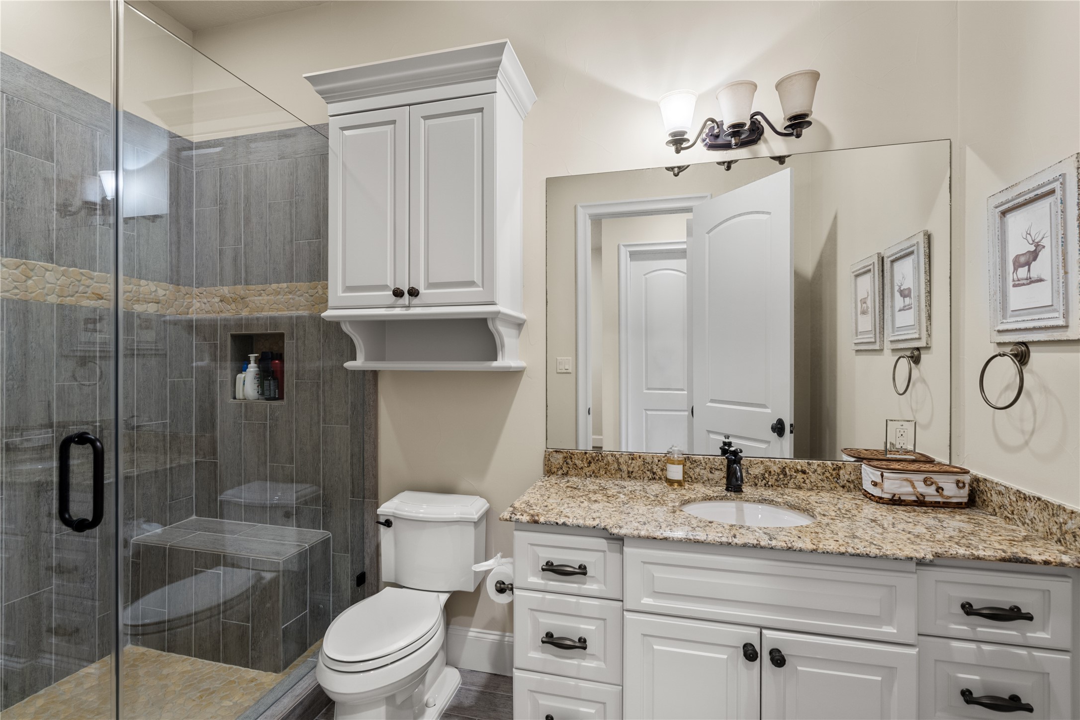 12349 Longmire Trace Conroe, TX 77304 - Photo 28 of 48 Spa-style bathroom with frameless glass shower, granite countertop, and extra storage to hide your secrets.