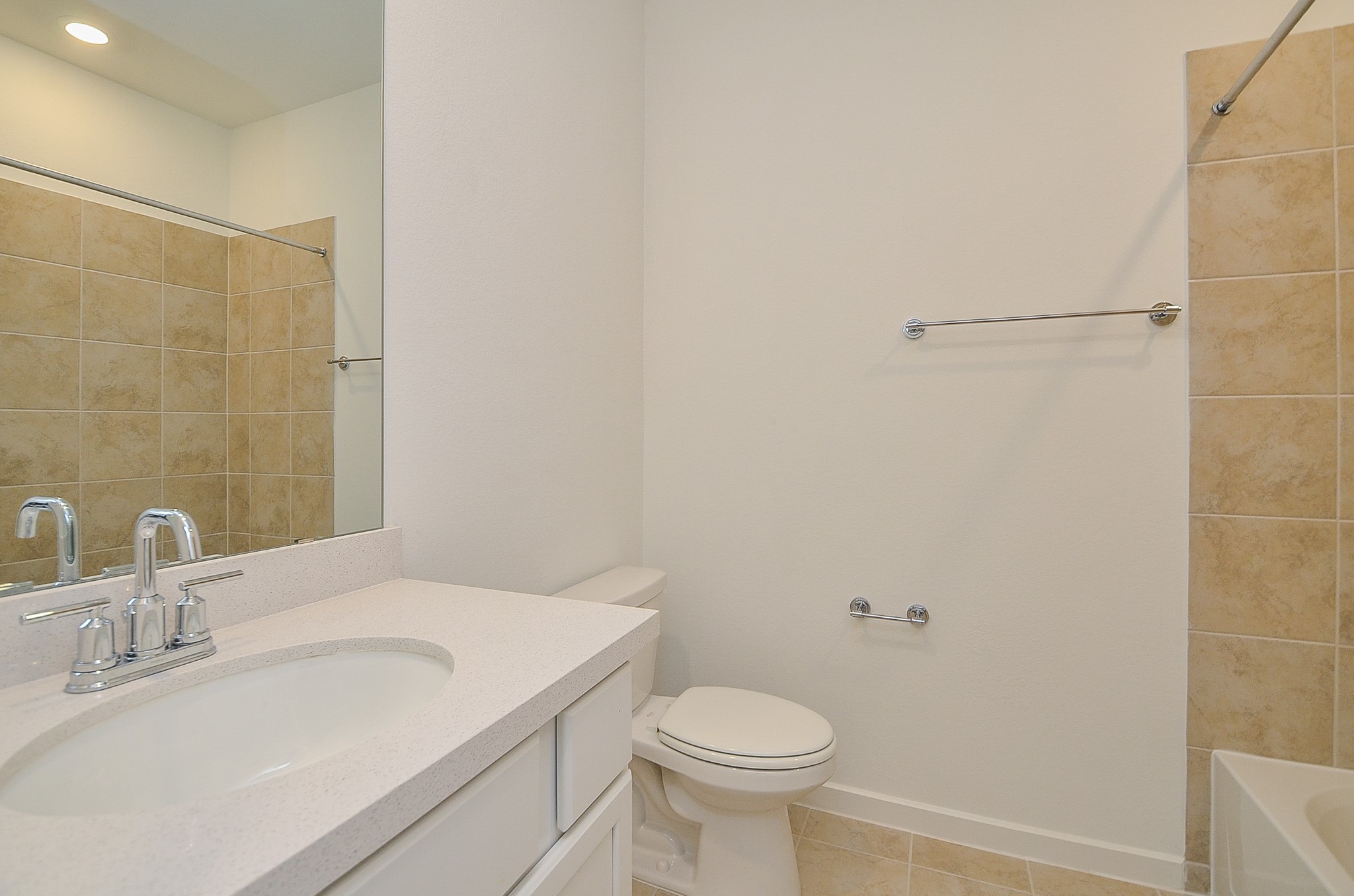 9727 Rialto Hts Drive Cypress, TX 77433 - Photo 29 of 37 This bathroom features a spacious, tiled walk-in shower with a glass door and a built-in shelf. Natural light enters through a high window, enhancing the bright and clean design.