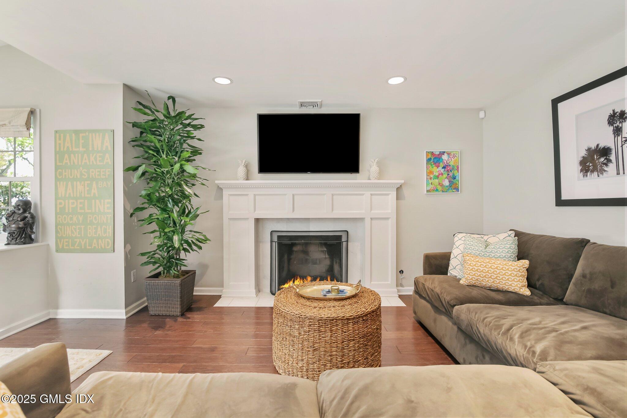 16 Split Timber Place Riverside, CT 06878 - Photo 16 of 34 a living room with furniture a flat screen tv and a fireplace