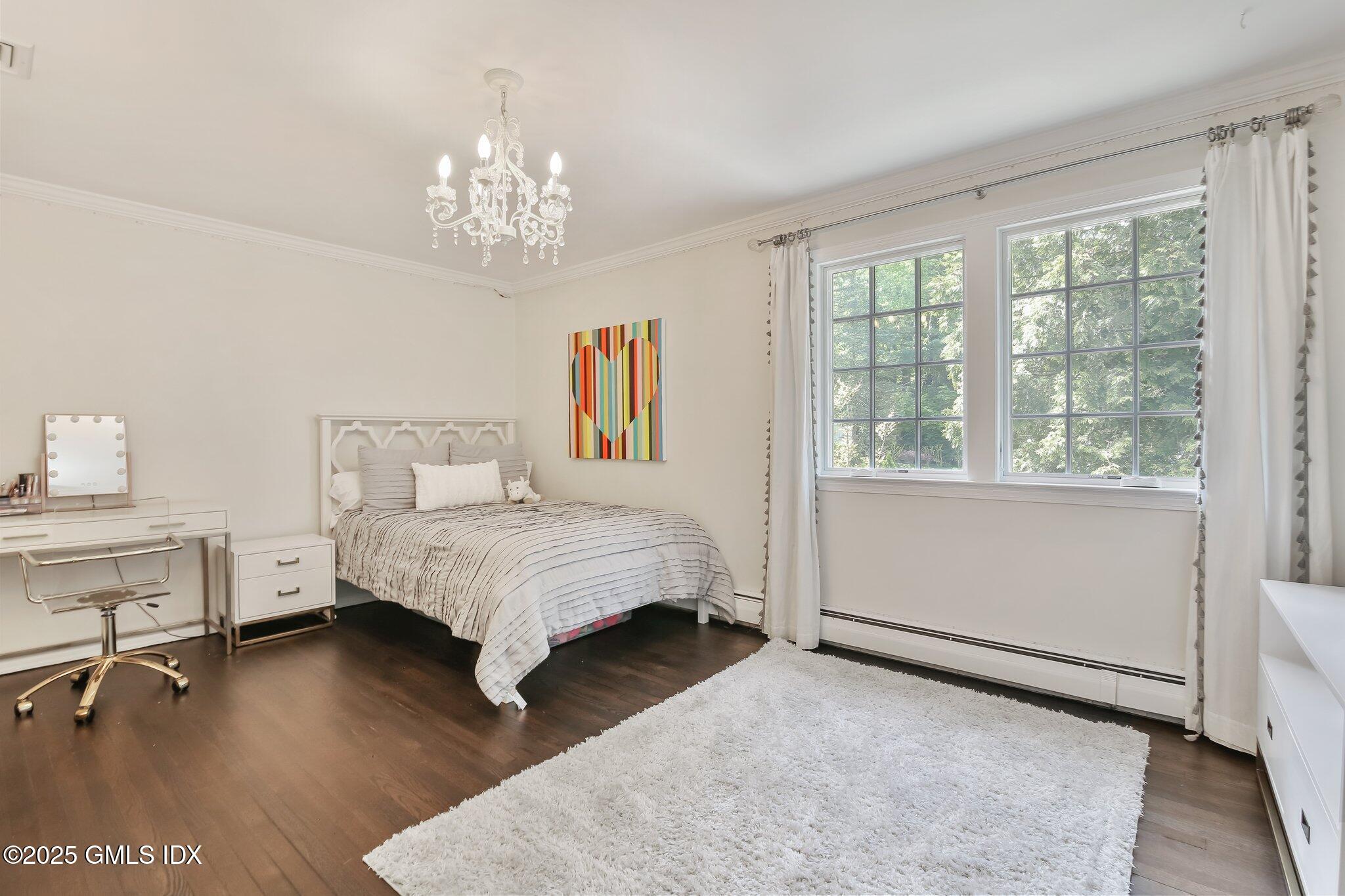 16 Split Timber Place Riverside, CT 06878 - Photo 25 of 34 a bed room with a bed and a chandelier